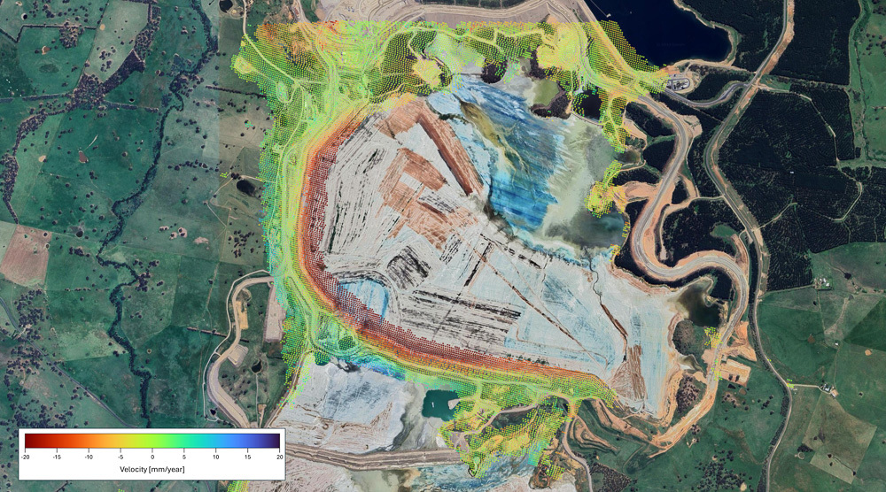 Aerial view of a landscape with a color-coded velocity map overlay.