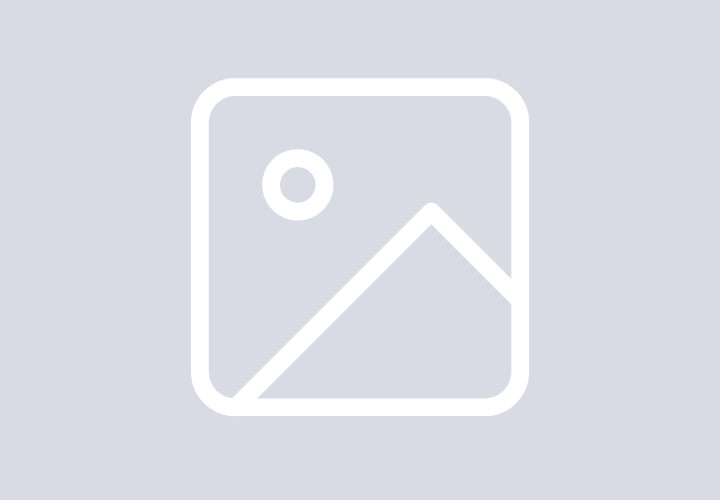 Large white spherical radar dome against a backdrop of the northern lights and starry night sky.