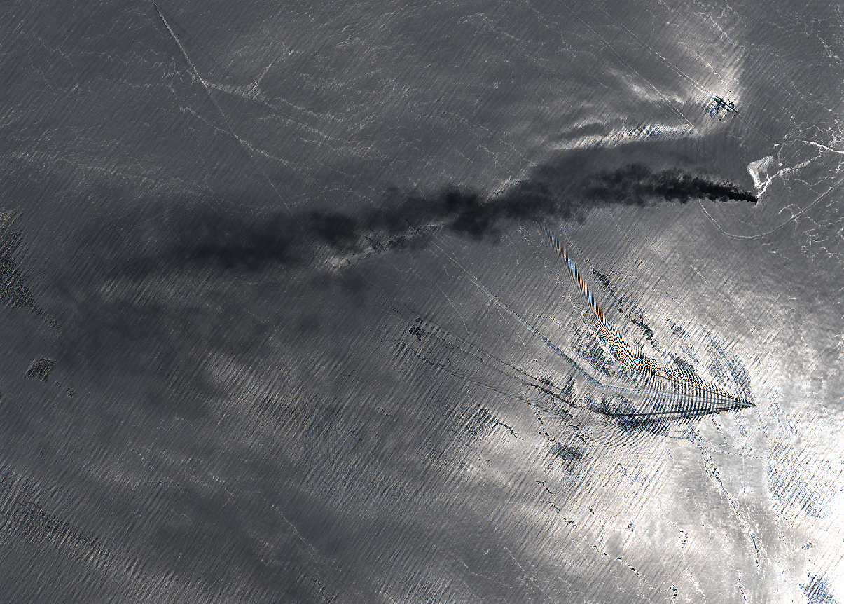 Satellite image showing a ship in the ocean with a long black smoke plume trailing behind it.